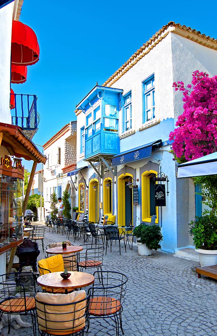 Stone street with bougainvillea flowers in Alaçatı, Izmir, Turkey
