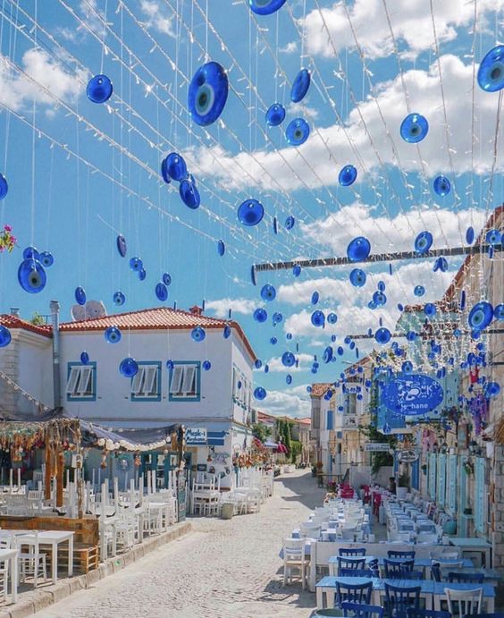 Stone street with bougainvillea flowers in Alaçatı, Izmir, Turkey